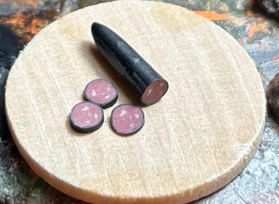 Dollhouse half a raw black pudding with slices 1/12 scale by Wyrdworldminiatures