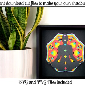 May include: A black frame containing a colourful mandala design. The mandala is layered and features a silhouette of a person sitting in a meditation pose at its centre. The text "SVG and PNG Files included" is at the bottom of the image.