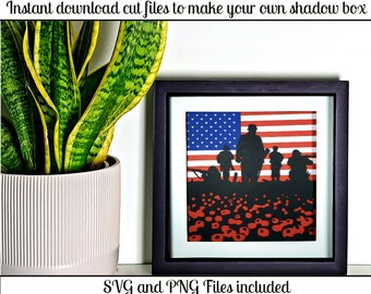 May include: A framed shadow box art piece featuring a silhouette of soldiers in front of an American flag. The artwork includes red poppies at the bottom. The text "Instant download cut files to make your own shadow box" and "SVG and PNG Files included" are visible.