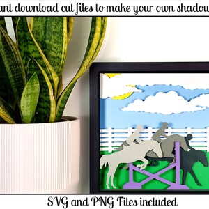 May include: A framed shadow box art piece depicting a horse jumping over a fence. The scene includes riders, horses, a blue sky with clouds, and a yellow sun. The text "Instant download cut files to make your own shadow box" and "SVG and PNG Files included" are visible.
