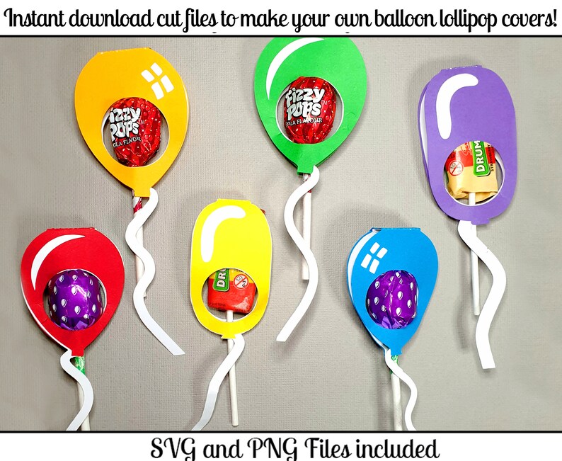 May include: Six colorful balloon lollipop covers with cut-out windows to display lollipops. The balloons are yellow, green, purple, red, yellow, and blue. The text "Fizzy Pops" and "Drum" are visible on the lollipops.