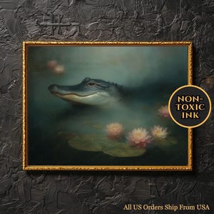 May include: A framed artwork featuring an alligator in a serene aquatic setting with lily pads and pink flowers. The artwork has a gold frame and the text "NON-TOXIC INK" is visible. The overall theme is nature and wildlife.