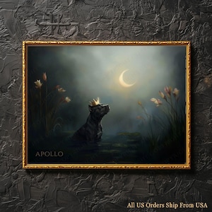 May include: A framed art print featuring a black dog wearing a gold crown, gazing at a crescent moon in a serene, watery landscape. The artwork has a gold frame and the word "APOLLO" is visible. The overall color palette is dark with soft, muted tones.