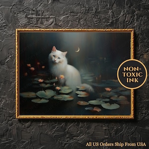 May include: A framed art print featuring a white cat with blue eyes, sitting among lily pads in a pond under a crescent moon. The artwork has a gold frame and the words "NON-TOXIC INK" are visible. The text "All US Orders Ship From USA" is also visible.
