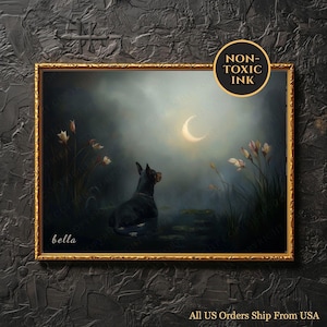 May include: A framed painting featuring a black dog gazing at a crescent moon in a serene, moonlit landscape. The artwork has a gold frame and includes the text "bella" and "NON-TOXIC INK". The painting depicts a tranquil scene with soft colors.