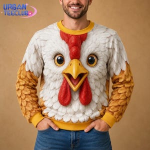 May include: A long-sleeve sweatshirt featuring a large, detailed graphic of a chicken face with white feathers, a yellow beak, and red wattles. The sleeves are patterned with brown feathers, and the collar and cuffs are solid yellow.