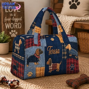 May include: A rectangular duffel bag featuring a patchwork design of denim and red and yellow plaid fabric. The bag displays embroidered dachshunds, paw prints, and the name Teresa in gold script. It has two matching fabric handles.
