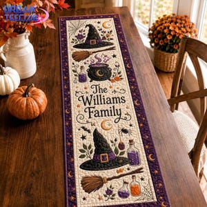 May include: A rectangular fabric table runner featuring a cream-colored center with a repeating Halloween-themed pattern of witch hats, brooms, cauldrons, potions, spiders, and webs. The text The Williams Family is printed in the center.