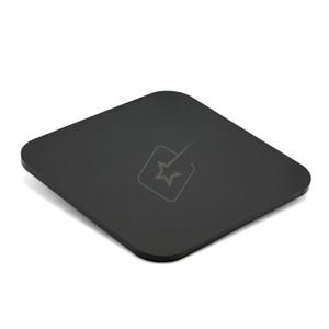 May include: A square, black coaster with rounded edges. A light gray logo featuring a star within a square is visible on the surface. The coaster is designed to protect surfaces from drink condensation and heat.