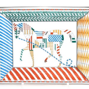 May include: Rectangular ceramic tray with a horse design. The horse is composed of colorful geometric shapes. The tray's border features blue stripes, orange and white stripes, green zigzags, and yellow triangles. A decorative piece for the home.