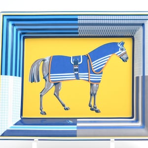 May include: Rectangular decorative tray with a horse illustration. The horse is blue with a blanket and saddle, set against a yellow background. The tray has a blue and white striped border with geometric patterns.