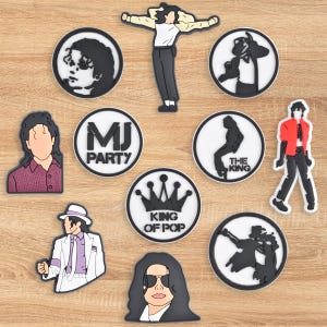 May include: A collection of black and white cartoon-style images and figures. The images include portraits, silhouettes, and figures of a famous singer. Some images are circular with text, including "MJ PARTY" and "KING OF POP".