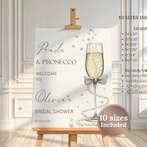 May include: A white sign on a wooden easel with the text "Pearls & Prosecco" and "Welcome to Olivia's Bridal Shower". A champagne glass with a bow and pearls is illustrated. Includes US and EU/AUS/UK sizes.