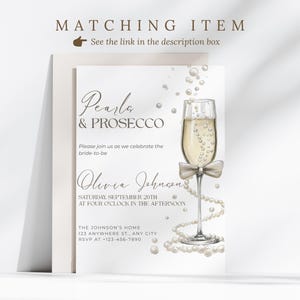 May include: An invitation card with the text "Pearls & Prosecco" and "Olivia Johnson" in elegant script. A champagne glass with a bow and pearl accents is featured. The card includes event details and RSVP information.
