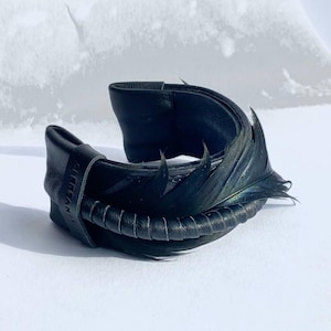 Black leather bracelet with ostrich feather. (Arm size 14-15cm)