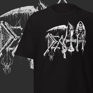 May include: Black t-shirt with a white graphic design. The design includes the word "DEATH" in a gothic font, a scythe, a spider web, and a hooded skull. The graphic is on the front of the shirt.