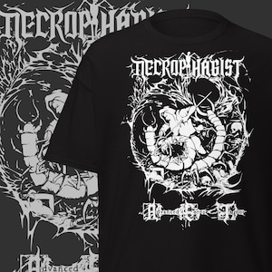 May include: Black t-shirt featuring a white graphic design with the band name "NECROPHAGIST" in a gothic font. The design includes an illustration of a figure and the words "Advanced Corpse Humor".