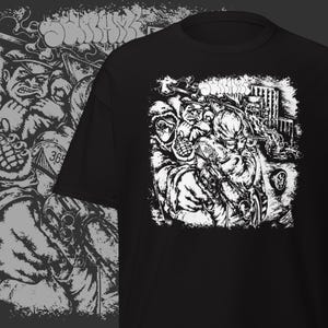 May include: Black t-shirt featuring a detailed white graphic of a chaotic scene with figures, buildings, and the number "365". The word "SONIKK" is at the top. The design has a gritty, illustrative style.