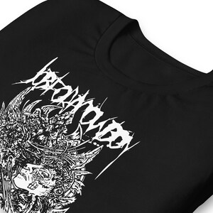 May include: Black t-shirt featuring a white graphic design. The design includes the word "BROWNHOOD" in a stylized font, along with an intricate illustration of a face and ornate details. The shirt is made of a soft material.