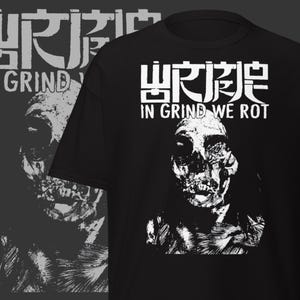 May include: Black t-shirt featuring a white skull graphic and the text "IN GRIND WE ROT". The design incorporates stylized Japanese characters and the word "GRIND".