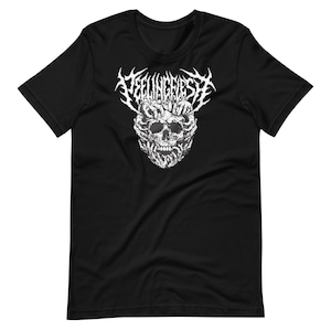 May include: Black t-shirt featuring a white graphic of a skull with intricate details and the text "FEELINGFLESH" above it in a stylized font. The design is centered on the front of the shirt. The shirt has short sleeves and a crew neck.