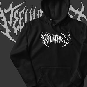 May include: Black hoodie with a white, stylized graphic that reads "TEELINGFIL". The hoodie has a drawstring hood and a front kangaroo pocket. A matching white graphic is in the background.