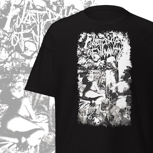 May include: Black t-shirt with a distressed, grayscale graphic. The graphic features the text "WASTE OF HUMANITY" in a stylized font, surrounded by a detailed, surreal illustration. The design includes figures and abstract elements, creating a dark, artistic aesthetic.