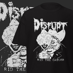 May include: Black t-shirt with a white graphic featuring the word "Disrupt" in a distressed font. The design includes a clown holding a mask and the text "Rid the Cancer."