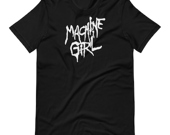 May include: Black t-shirt with the white text "MACHINE GIRL" in a stylized, gothic font. The short-sleeved shirt is made of a soft material and is suitable for casual wear. The design is centered on the chest.