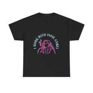 May include: Black t-shirt with a graphic of a woman smoking a cigarette, with the text "I WORK WITH INDIE GAMES" in a semi-circle around the image. The graphic is in pink and light blue.