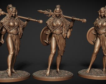 May include: Bronze-colored figurine of a warrior woman holding a spear and shield. The figure is clad in a draped garment and adorned with a feathered cape and headpiece. The statue is on a circular base.