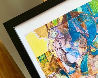 May include: Abstract art print in a black frame. The artwork features a mix of colors, including yellow, blue, brown, and green. The painting has a textured appearance with visible brushstrokes and lines. The artwork is mounted on a white mat.