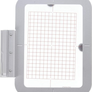 May include: A gray embroidery hoop with a white gridded surface. The hoop has a clear plastic window and a metal latch. The text "SA215H" is printed on the bottom right corner of the hoop.
