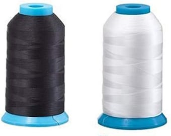 May include: Two spools of thread, one black and one white, with blue plastic bobbins.