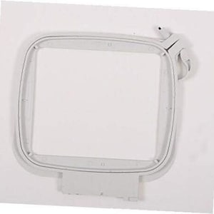 May include: White plastic embroidery hoop with a square opening. The hoop has a locking mechanism on the top right corner.