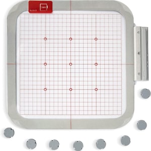 May include: A silver embroidery hoop with a white grid and red markings. The hoop is 10 inches in diameter and has a clear plastic sheet inside. Nine small gray plastic feet are scattered around the hoop.