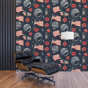 May include: Dark blue wallpaper featuring a repeating pattern of American flags, military helmets, and red poppies. The design has a vintage, patriotic aesthetic. The wallpaper is installed on a wall in a room with a black leather chair and wooden floor.