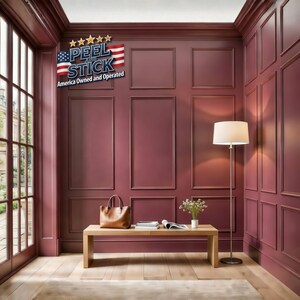 May include: A room with burgundy paneling, a wooden bench, and a tan leather handbag. A floor lamp with a white shade stands to the right. The wall features a "PEEL and STICK" sign with an American flag design. The room has a wooden floor and a large window.
