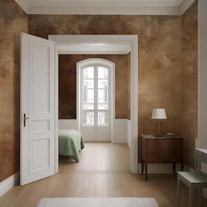 May include: Interior shot of a bedroom with a partially open white door. The room features light wood flooring, a brown textured wall, and a small wooden nightstand with a lamp. A bed with a green blanket is visible through an arched doorway.