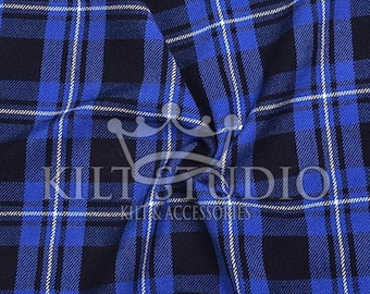 May include: Close-up of a blue, black, and white plaid fabric. The fabric has a repeating pattern of intersecting lines, creating a grid-like design. The text "KILT STUDIO" and "KILTS & ACCESSORIES" is visible.