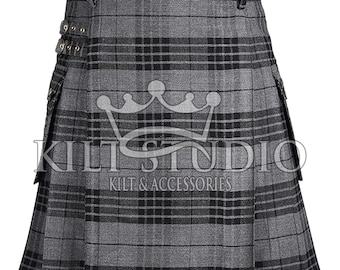 May include: A gray and black plaid kilt with pleats and decorative buckles. The kilt has a classic design with a structured waistband and pockets. The text "KILT STUDIO KILT & ACCESSORIES" is printed on the front.