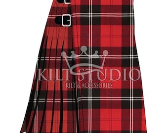 May include: A red, black, and white plaid kilt with two black leather straps and silver buckles. The kilt is pleated and features the text "KILT STUDIO KILTS & ACCESSORIES".