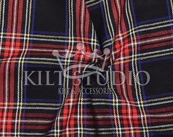 May include: Close-up of a red, black, blue, and yellow plaid fabric. The fabric has a repeating pattern of intersecting lines. The text "KILT STUDIO KILTS & ACCESSORIES" is printed on the fabric.