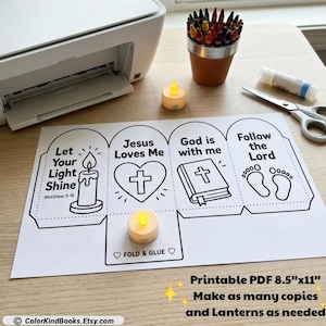 May include: A printable paper craft sheet featuring four panels with religious illustrations and text including Let Your Light Shine, Jesus Loves Me, God is with me, and Follow the Lord. The sheet includes fold and glue tabs for assembly.