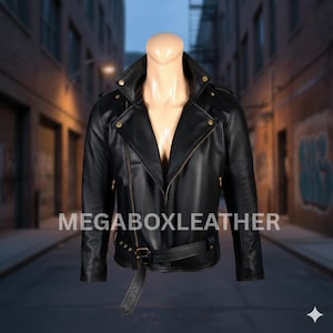 May include: Black leather jacket with an asymmetrical zipper, notched lapels, and a belted waist. The jacket features gold-colored hardware and is displayed on a mannequin. The text "MEGABOXLEATHER" is visible on the front.
