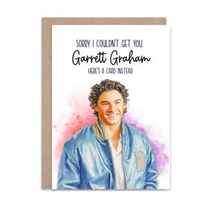 May include: A greeting card featuring a watercolor-style illustration of a smiling person with dark curly hair wearing a blue varsity jacket with a letter B on the chest. The text reads: SORRY I COULDN'T GET YOU Garrett Graham HERE'S A CARD INSTEAD.