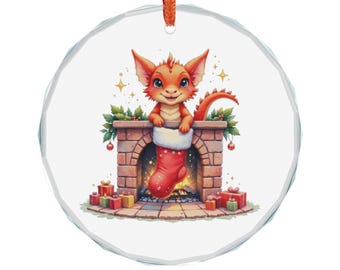 May include: A round Christmas ornament featuring a cartoon dragon in a red stocking inside a brick fireplace. The dragon is orange with a red tail. Presents and greenery surround the fireplace. The ornament has a red ribbon for hanging.