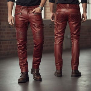 May include: Burgundy leather pants with ribbed detailing on the knees and zippered pockets. The back features quilted stitching on the pockets and waistband. The pants are shown from the front and back views.