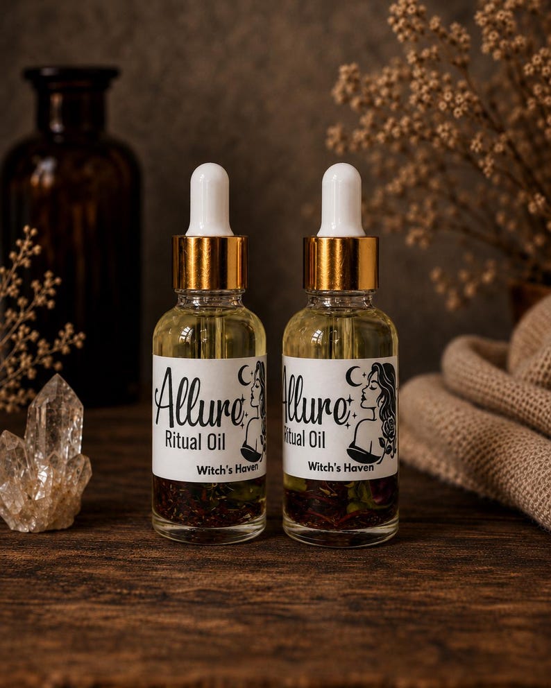 May include: Two clear glass dropper bottles filled with light yellow ritual oil containing visible dried herbs. Each bottle features a white label with the text Allure Ritual Oil and Witch's Haven, accompanied by a black line art illustration of a person.