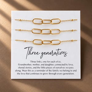 May include: Three gold-toned chain bracelets, each featuring three elongated oval links and small beads on a white display card. The card includes the text Three generations and a poem about family connections, grandmother, mother, and daughter.